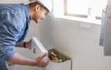 Toilet maintenance, plumber and man fix cistern, home renovation and builder service. Contractor, bathroom tank plumbing and handyman on industrial technician for leak, broken pipe and sewer drainage