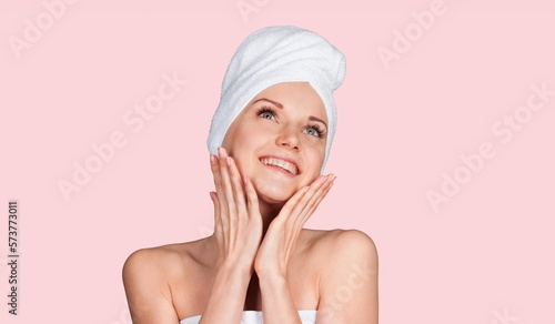 Happy young woman touching perfect skin on background
