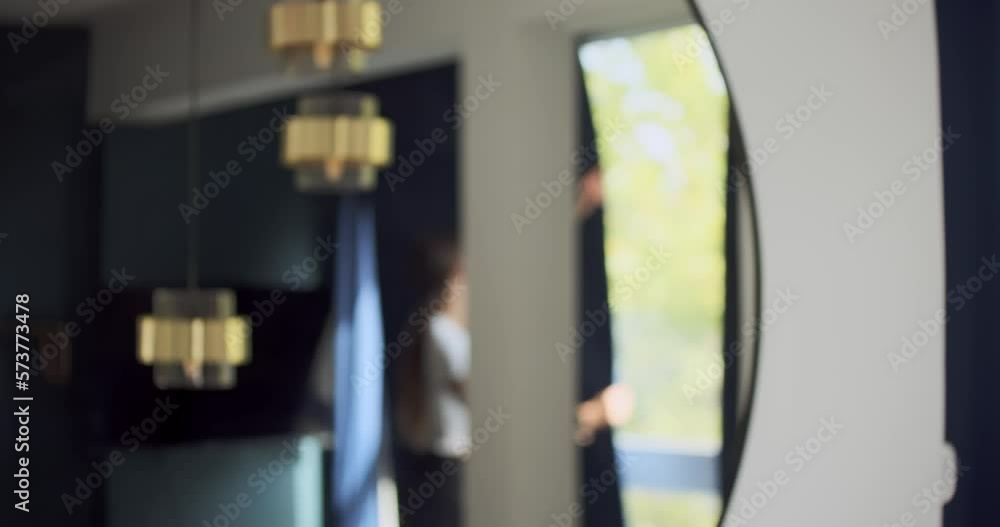 Girl closing curtains at home, intentional blur, abstract concept Girl closing curtains at home, intentional blur, abstract concept