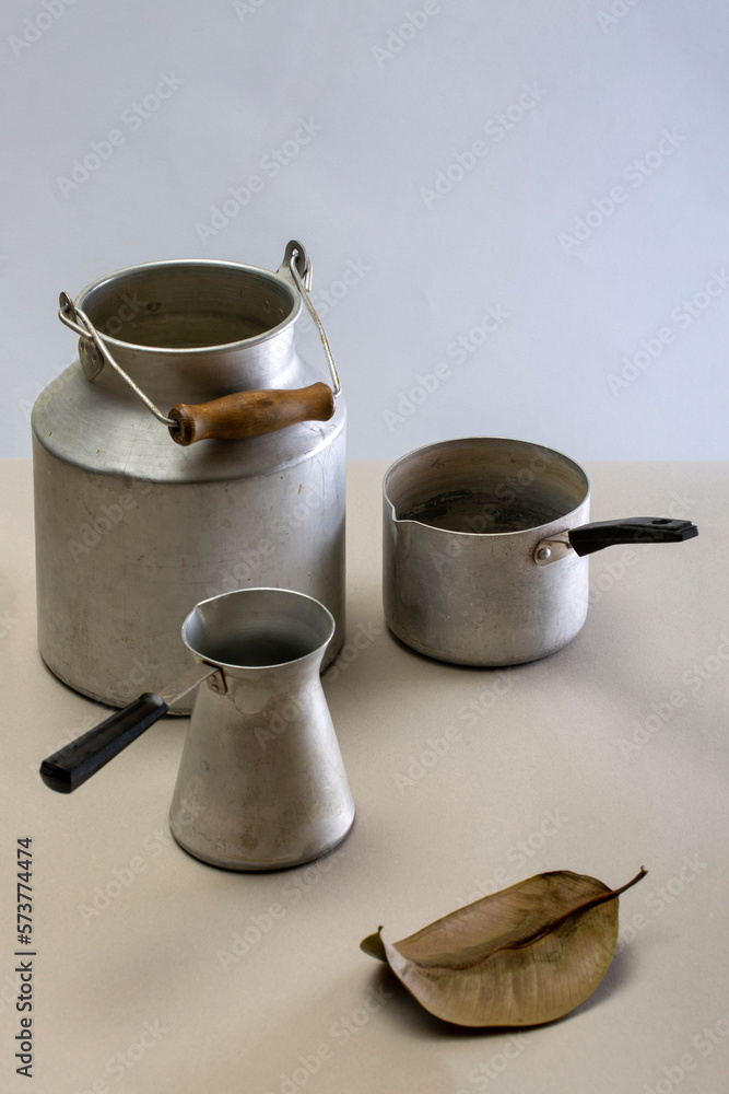 Still life with aluminum dishes on a gray background