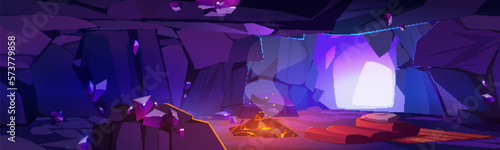Dark cave inside scene for fantasy game background. Cartoon vector illustration with fire, pillow on bed in tunnel. Crystal and rock in underground ancient cavern or dungeon with light from entrance.
