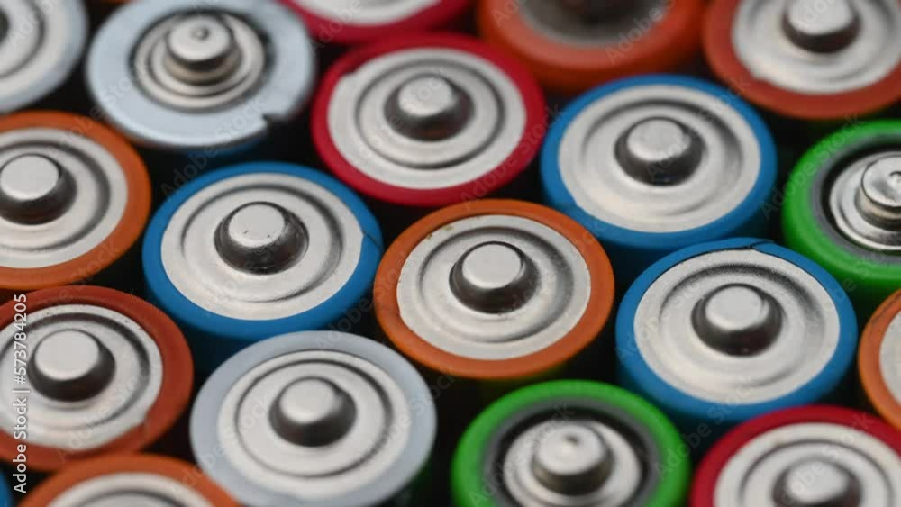 Close-up of batteries revolving on a turntable top view. Background of colorful batteries.The concept of hazardous waste, disposal of used batteries, ecology. Close-up of batteries revolving on a turntable top view. Background of colorful batteries.The concept of hazardous waste, disposal of used batteries, ecology.