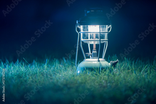 antique kerosene lamp with lights On the lawn at night.Vintage colors picture. 