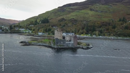 Aerial orbits Eilean Donan Castle on island near Ardelve, Scotland photo