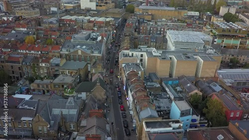 Low aerial flyover of quaint, narrow Brick Lane in London, UK photo