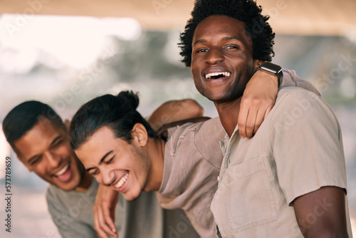 Friends laughing together, men outdoor with hug and funny, relax and happy with diversity, smile and freedom. Friendship, humor and bonding with solidarity, support and young people with trust