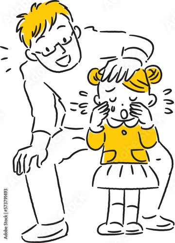 泣いている女の子を慰める若いお父さん