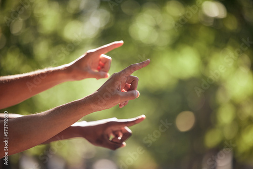 Pointing, gesture and hands in nature for bird watching, hiking and view. Summer, travel and fingers gesturing for a location, adventure and showing while walking in a park for fitness and cardio © T Mdlungu/peopleimages.com