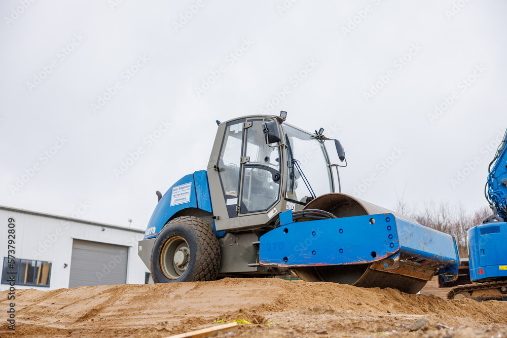 Gravel is compacted with a bulldozer at a construction site