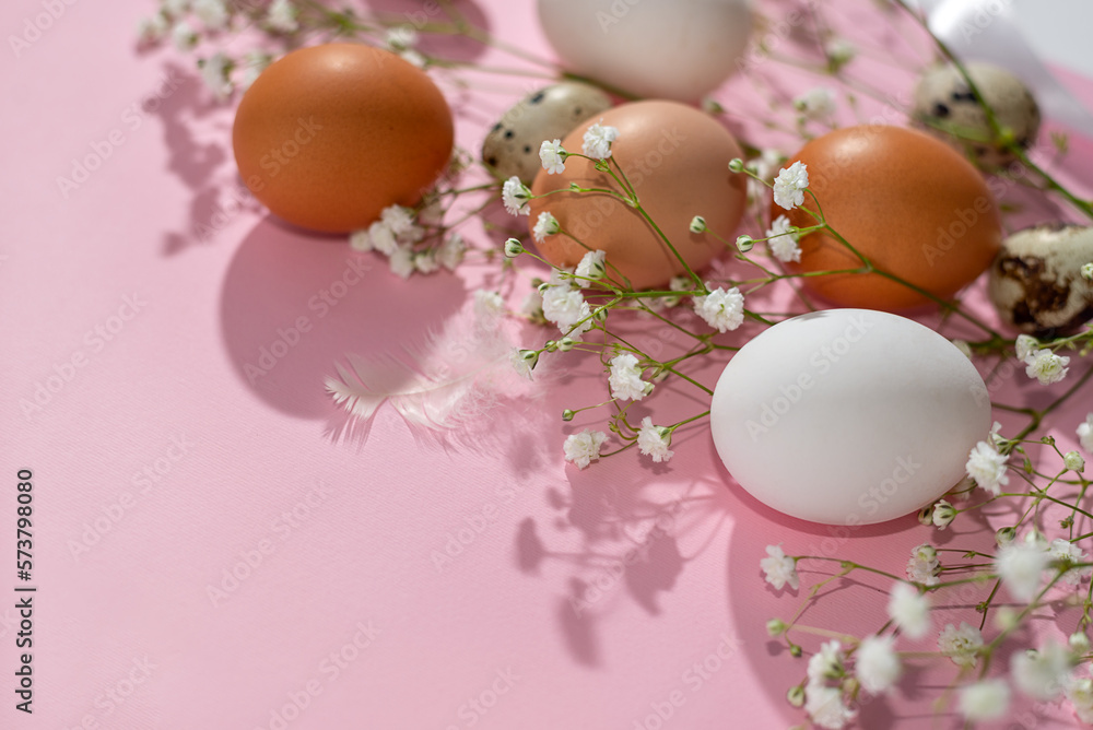 Aesthetic Easter spring minimalist banner, floral composition with natural color eggs and gypsophyla flowers on pastel pink background, copy space