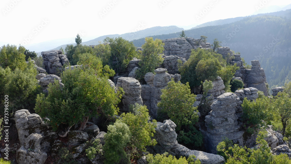 Granite rock formations and green vegetation. View of mountains in the background. Stunning mountains landscape. Granite rock formations and green vegetation. View of mountains in the background. Stunning mountains landscape.