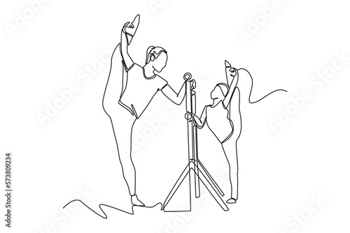 Continuous one line drawing Ballet school teacher helps young ballerinas practice in class. Class in action concept. Single line draw design vector graphic illustration.
