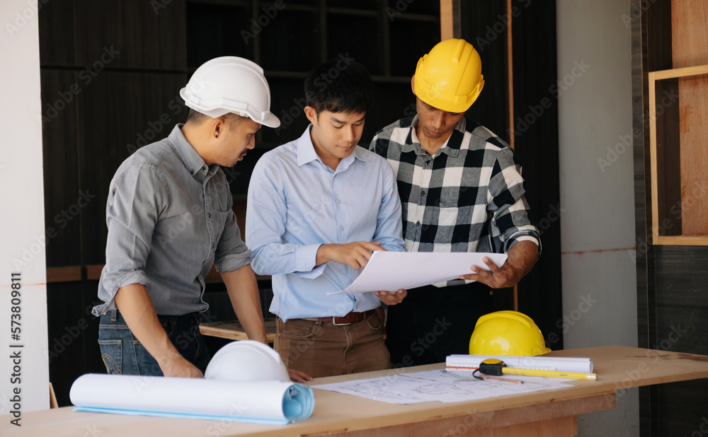 Handsome young man team architect on a building industry construction site in son light Handsome young man team architect on a building industry construction site in son light