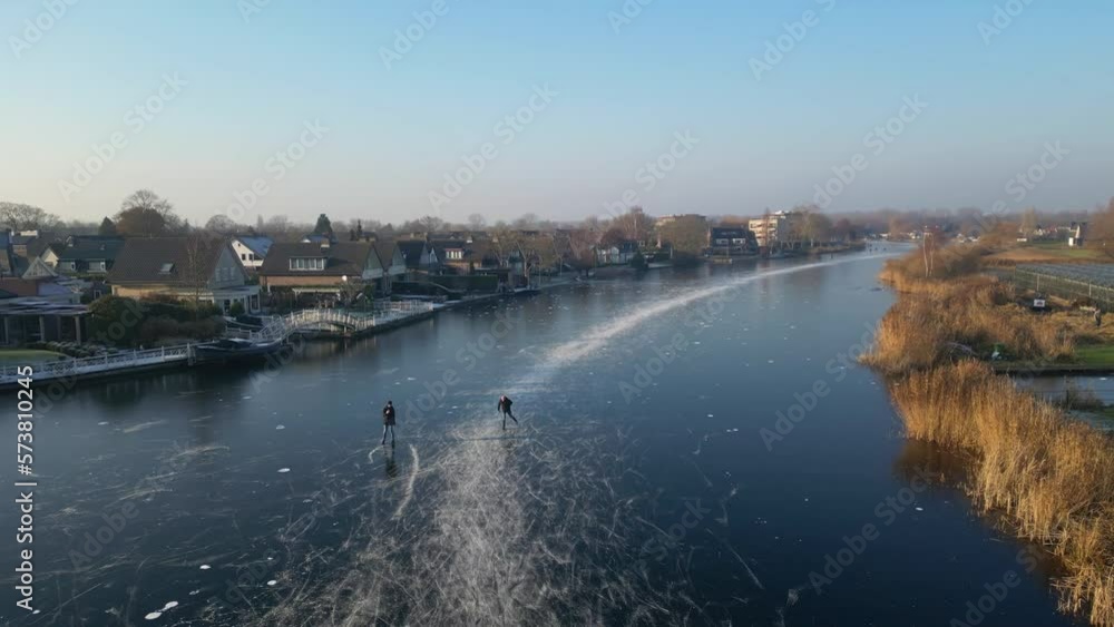Ice Skating - People Skating On The Frozen River In Hendrik-Ido-Ambacht, Netherlands. - aerial Ice Skating - People Skating On The Frozen River In Hendrik-Ido-Ambacht, Netherlands. - aerial