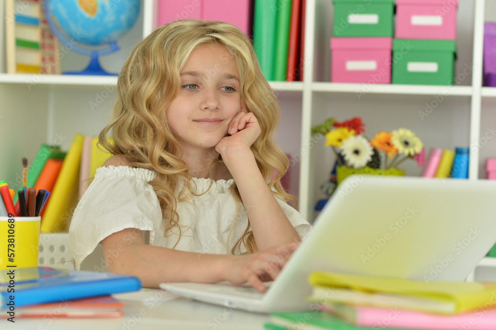 girl using laptop at desk at home girl using laptop at desk at home