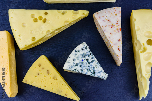 Various types of cheese on a slate board. Top view