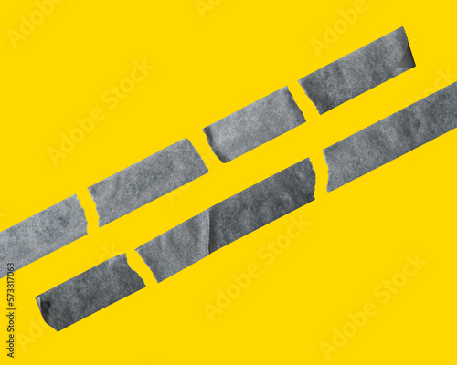 Set of different black sticky tapes. Torn crumpled sellotape pieces isolated on yellow background photo