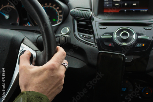 Man driving car. Auto interior. Man hand on steering wheel. Auto dashboard.  Journey concept. Personal transport. Inside the car. Speed background. Driver in car.  © Nataliia