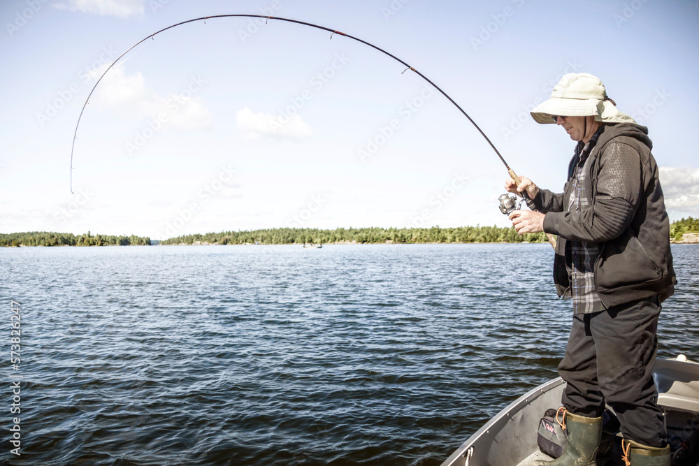 Fisherman On The Lake Nipissing During The Catch Fisherman On The Lake Nipissing During The Catch