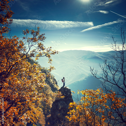 Hiker standing on top of the narrow rock formation photo