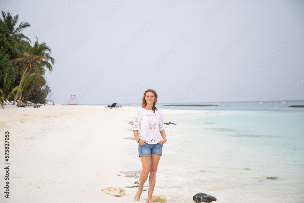 woman walking on tropical beach pastel colors