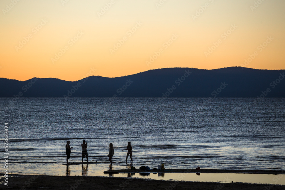 Friends at sunset beside Lake Tahoe. Friends at sunset beside Lake Tahoe.