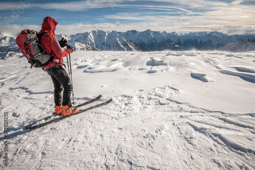 A ski mountaineer stands on a plateau above Devero, Ossola, Italy. photo