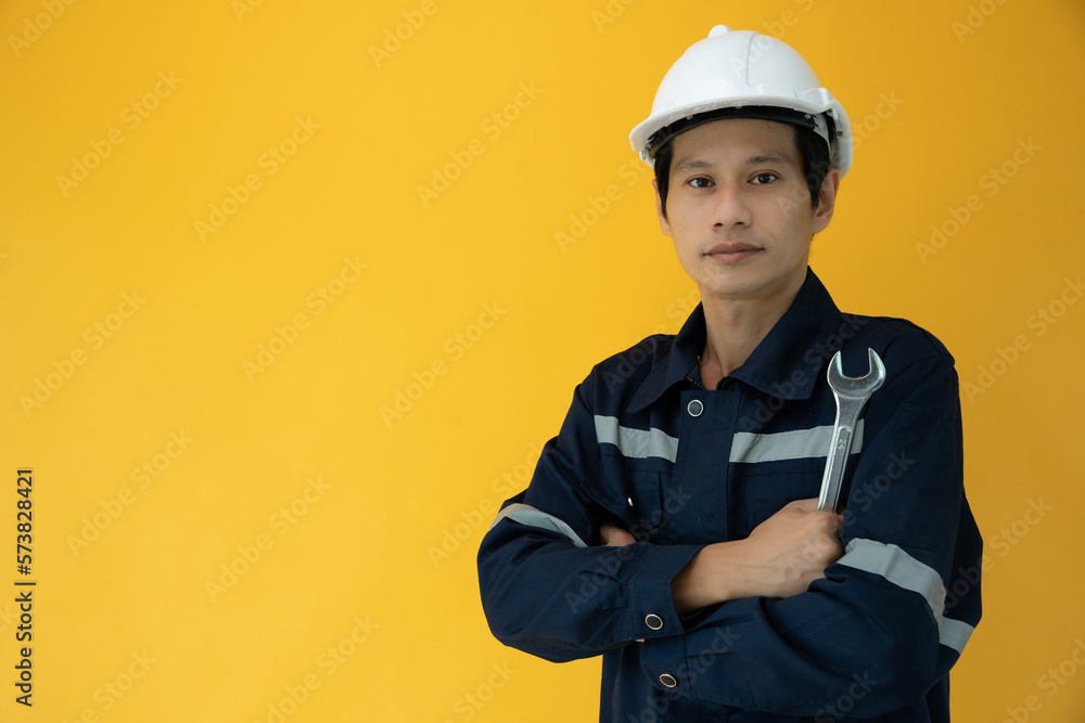 Engineers wear safety on color back ground. The inspectors crossed their arms proudly in the engineer project that they took the responsibility of inspecting. Service ..