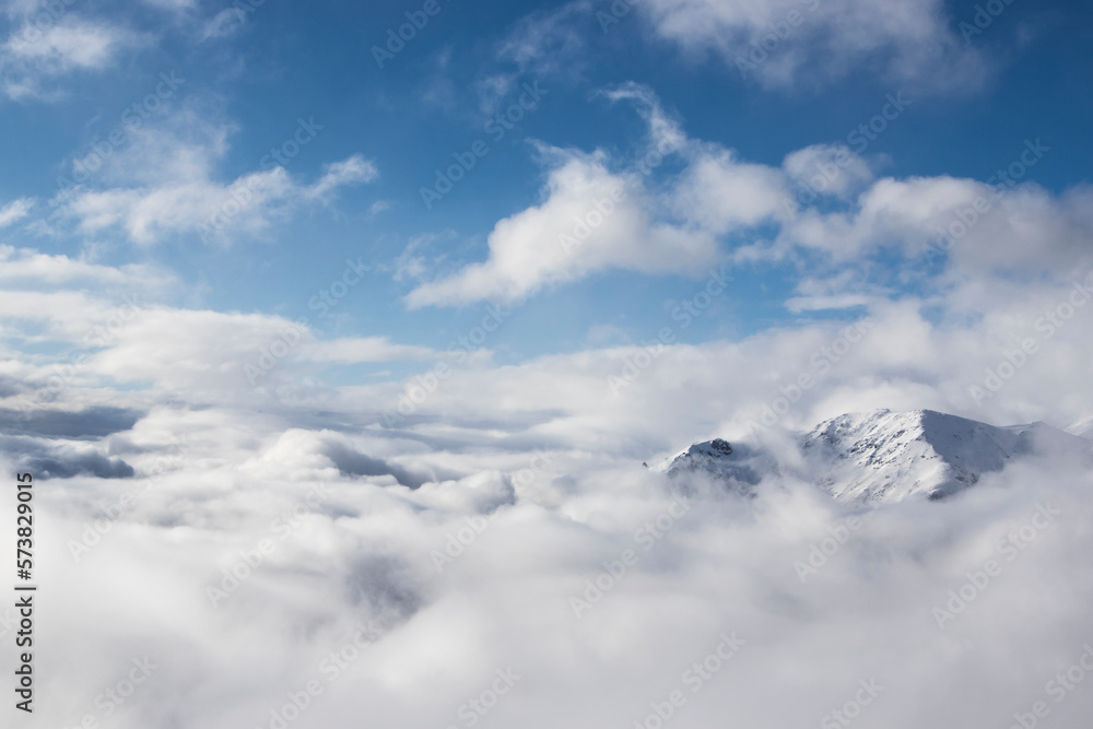The Peak Of A Snow Covered Mountain Top Pokes Above The Clouds In Bariloche, Argentina, Usa The Peak Of A Snow Covered Mountain Top Pokes Above The Clouds In Bariloche, Argentina, Usa
