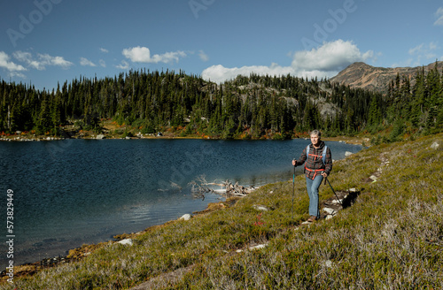 Woman hiking alongÂ lakeshore, Pemberton, British Columbia, Canada photo