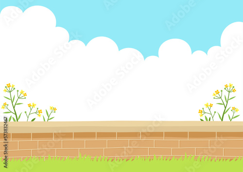 Wildflowers with brick wall. Spring nature background. © soyon