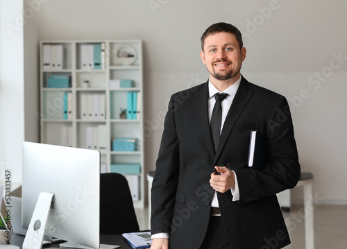 Male accountant with notebook in office