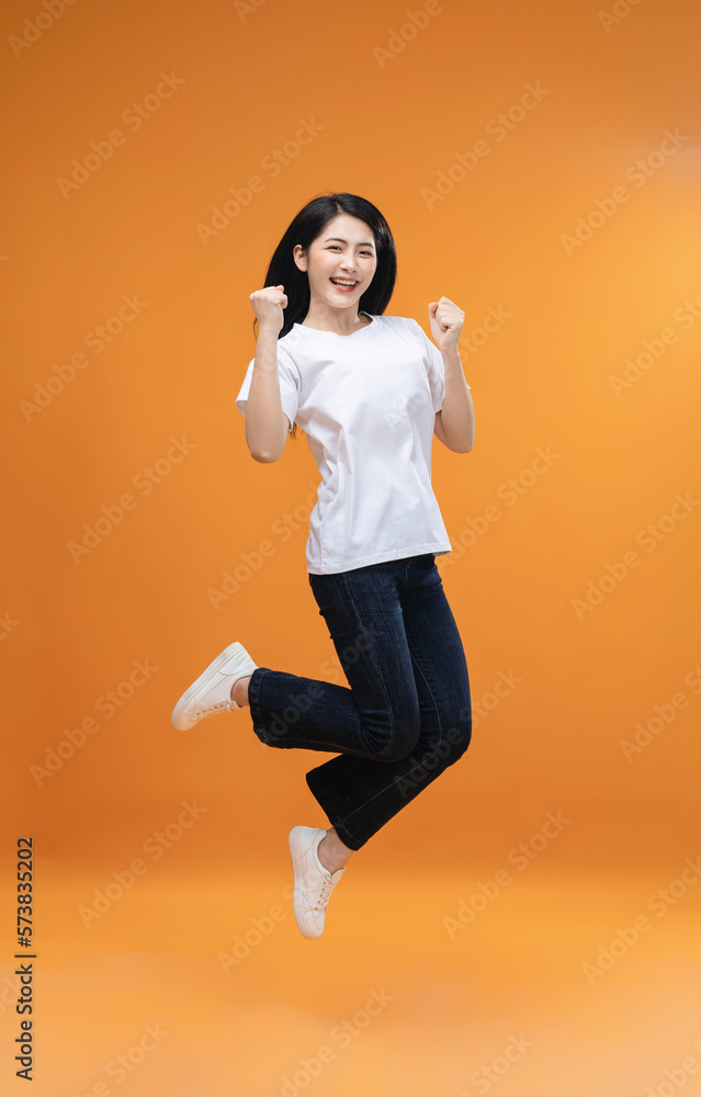 Full length image of young Asian girl on background Full length image of young Asian girl on background