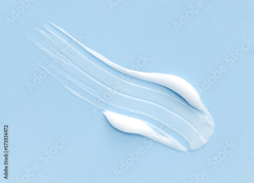cosmetic smears cream texture on pastel blue background