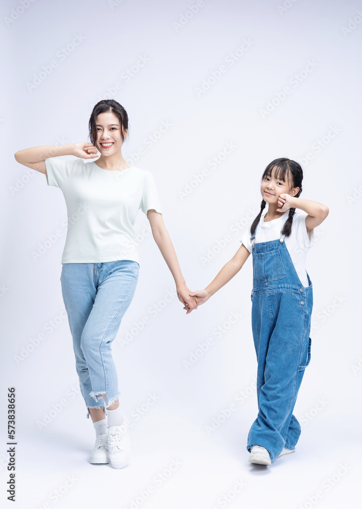 Image of Asian mother and daughter on background Image of Asian mother and daughter on background