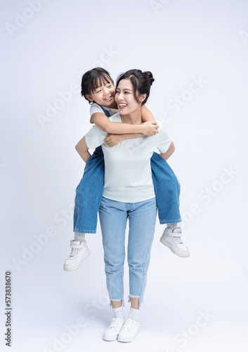 Image of Asian mother and daughter on background
