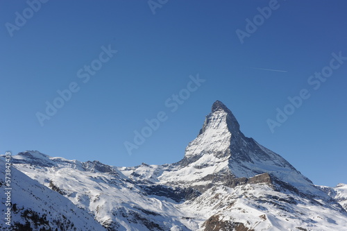 Matterhorn mountain peak  in Alps in winter with snow and clear blue sky in Cervinia, Italy and Zermatt, Switzerland. Beautiful and magnificent landscape on a sunny day © piotrmilewski