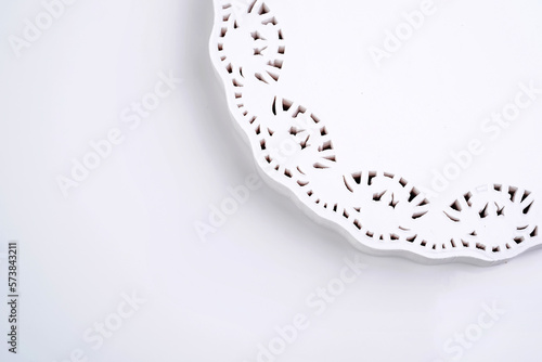 Round white lacy napkin isolated on white background, copy space. Clipping path