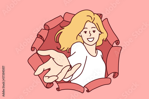 Happy woman stretching open palm through hole in torn paper to make Follow me gesture or make good offer. Positive woman reaching for screen making wanting to take item or invite you 