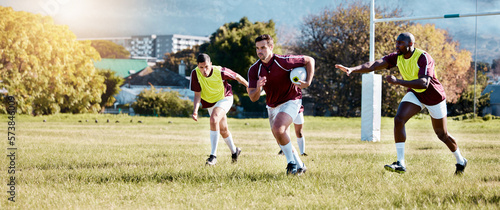 Rugby, athlete on field and sport game with men, team and player with ball, fitness and active outdoor. Exercise, sports training and running, teamwork with competition and action with energy