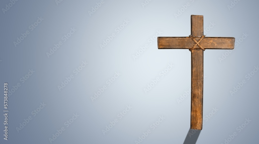 Wooden cross on color background. Christianity Concept.