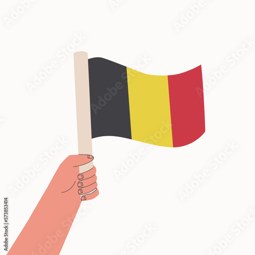 Flag of Belgium. National flag of the country in hand. Vector cartoon illustration. © Irina Popova