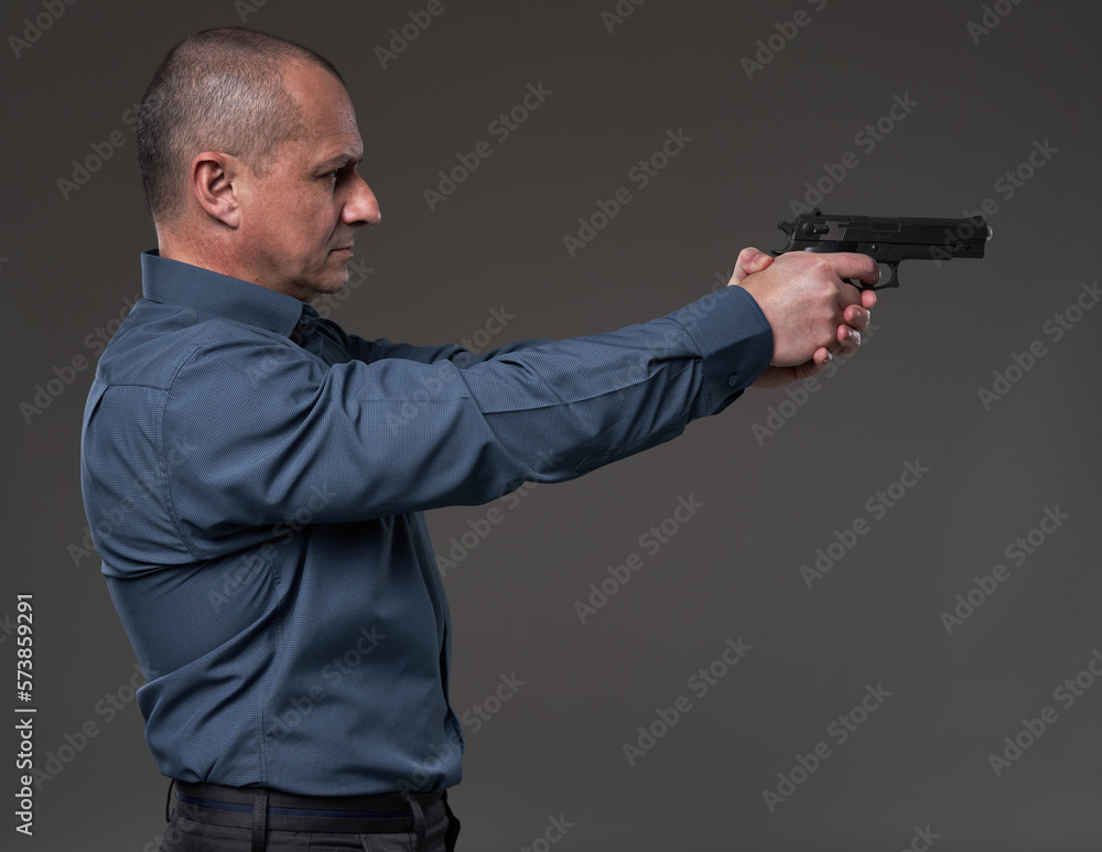 Mature businessman gunning down the competition Mature businessman gunning down the competition