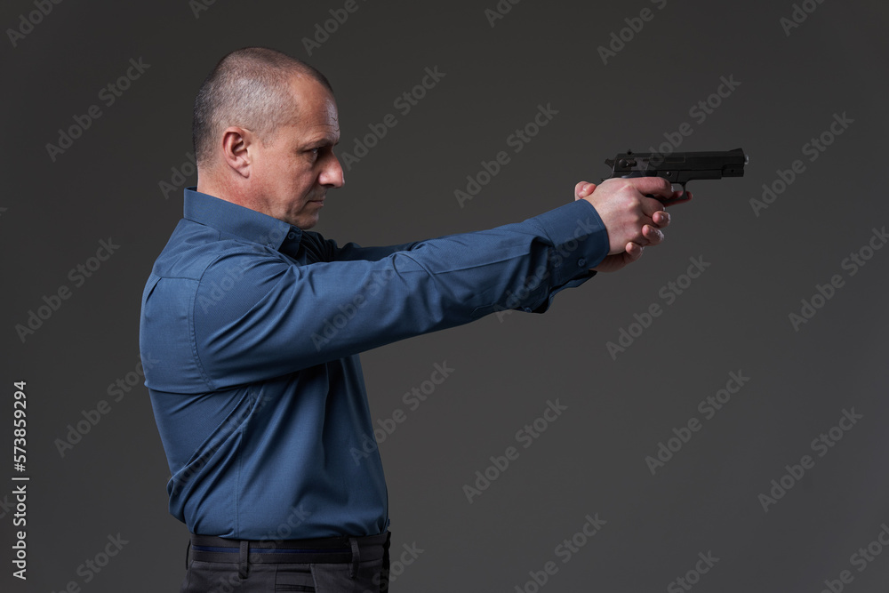 Mature businessman gunning down the competition Mature businessman gunning down the competition