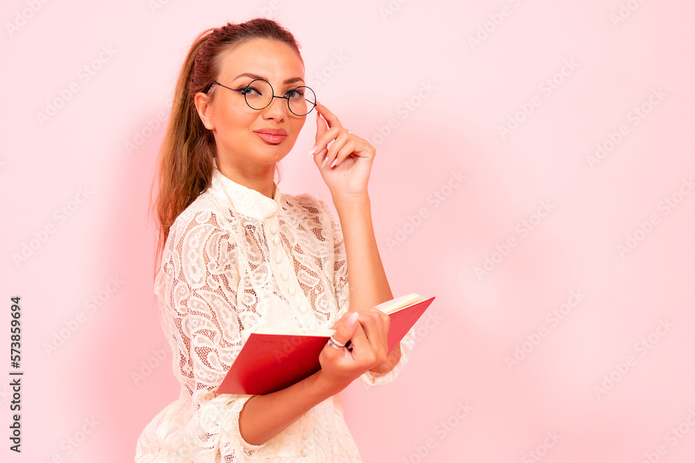 Pink background, girl reading books, book lover, student and many books, close-up Pink background, girl reading books, book lover, student and many books, close-up
