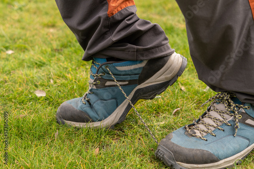 man stumble over the laces of her hiking boots photo