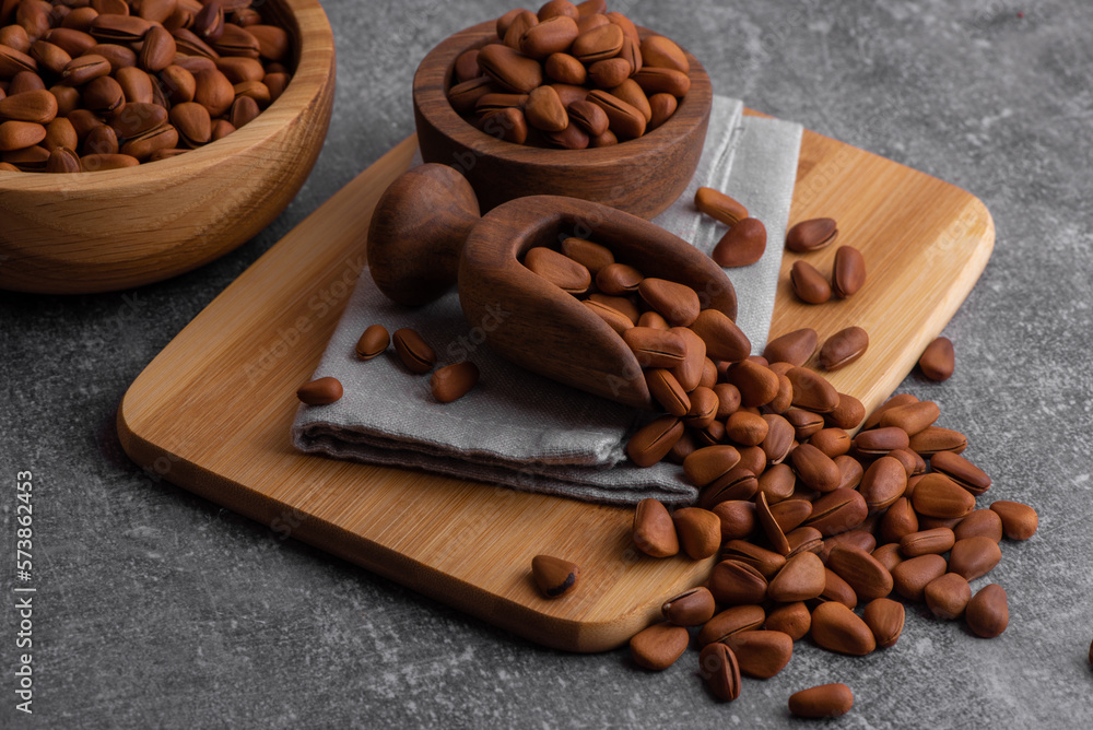 Fototapeta premium Pine nuts shelled and peeled. Сedar nuts. Toasted Organic Healthy Food.