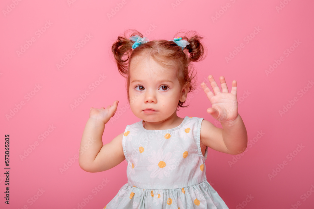 baby girl in a beautiful dress sitting on a pink background baby girl in a beautiful dress sitting on a pink background