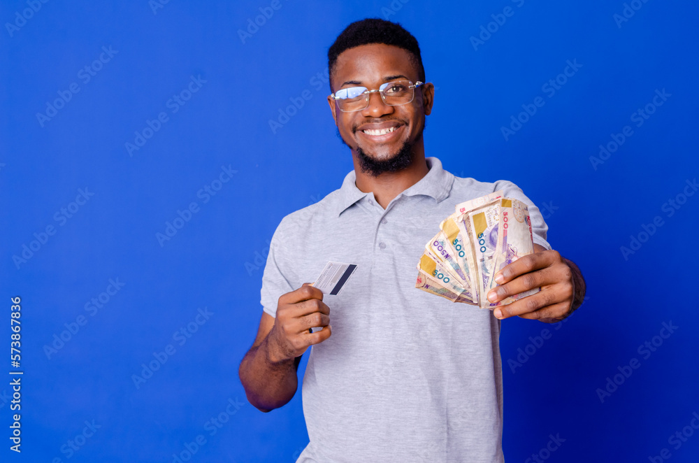 Close-up portrait of his he nice attractive handsome glad successful cheerful guy holding in hands fan cash new bank card. Close-up portrait of his he nice attractive handsome glad successful cheerful guy holding in hands fan cash new bank card.