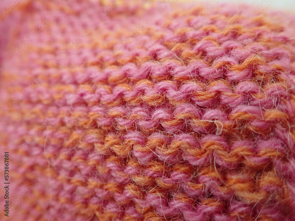 knitting from an orange and pink wool